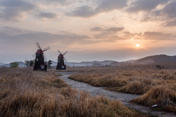 Fototapeta premium The beautiful landscape of windmill town in the early morning at dawn.