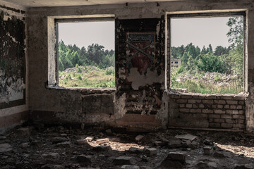 Fototapeta na wymiar View through the window of an abandoned building to a secret USSR military city