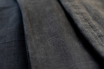 Detail of different black denim fabrics. Black jeans.