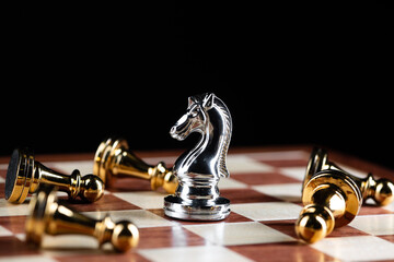 Silver knight chess defeats gold pawns on board.