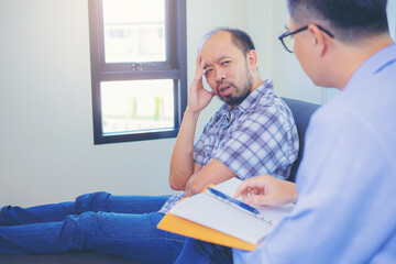 Doctor or psychiatrist Consultation with depressed male patient in clinic