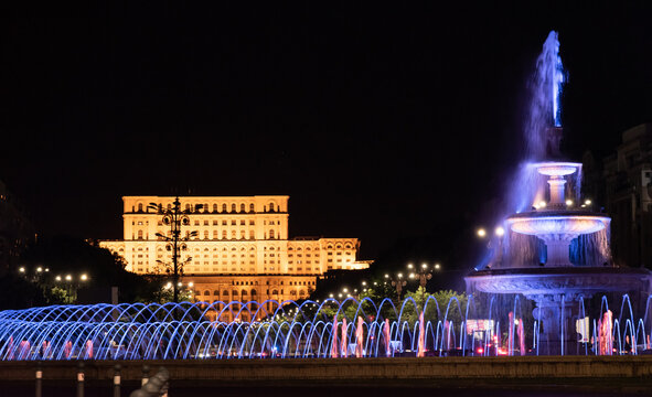 Illuminated main fountain and people's house (Parliament House) in Bucharest, Romania, 07.23.2020