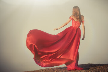 woman in a long red dress. Back view