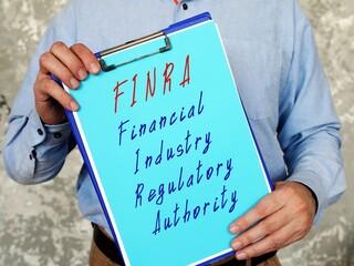 Financial Industry Regulatory Authority FINRA sign on the sheet.