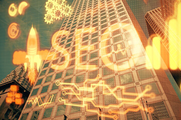 SEO hologram on city view with skyscrapers background double exposure. Search optimization concept.