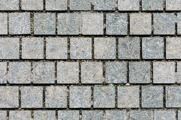 Brickwork from gray bricks in park. Background