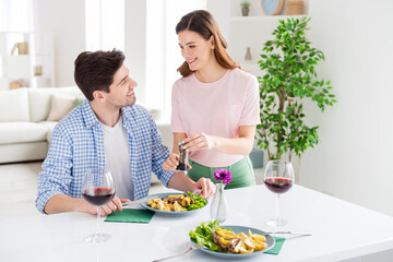 Obraz na płótnie Canvas Portrait of his he her she two nice attractive careful cute cheerful cheery spouses eating tasty fresh meal dish girl adding pepper staying home in light white interior kitchen house apartment