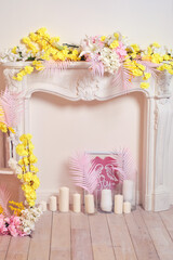 Decorative fireplace with yellow and red flowers, pink wall background