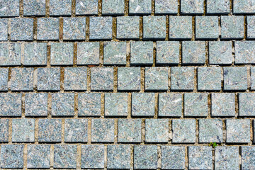 Brickwork from gray bricks in park. Background