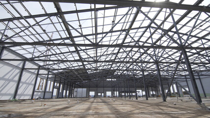 Construction of modern factory or warehouse, modern industrial exterior, panoramic view. Modern storehouse construction site, structural steel structure of new commercial building against.
