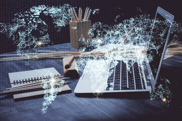 Computer on desktop with social network hologram. Double exposure. Concept of international people...