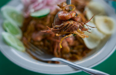 Delicious spicy Chinese noodles with shrimps at Indonesian street food market 