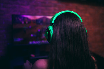 Naklejka premium Computer games, playing place, young gamer playing video games with headphones