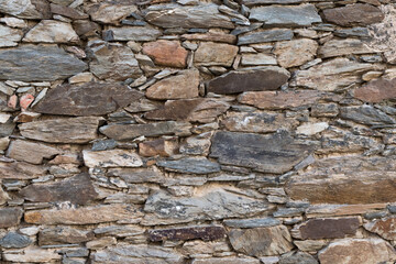 old stone wall. brown and grey stone texture