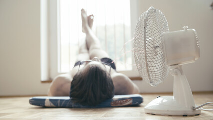Person relax at home with ventilator blowing