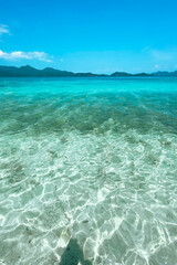Clear water on the island,Bright blue sea and wooden boat The tourism