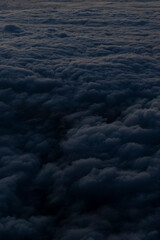 selective focus, night sky, fluffy clouds at sunset from a height of the plane window