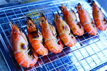 Grilled shrimp (Giant freshwater River prawn) grilling with charcoal at home, Natural Light in the evening. Bangkok, Thailand