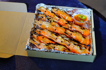 Grilled shrimp (Giant freshwater River prawn) grilling with charcoal at home, Natural Light in the evening. Bangkok, Thailand