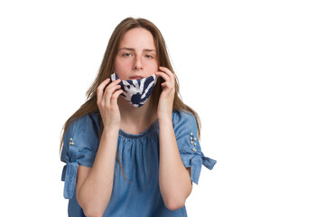 A young girl with long hair in a blue dress. Isolated on a white background