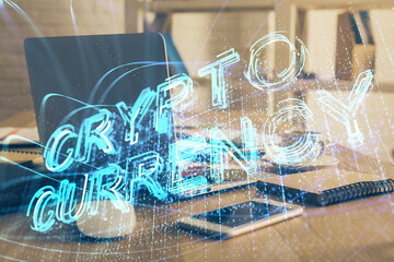 Multi exposure of blockchain theme hologram and table with computer background. Concept of bitcoin crypto currency.