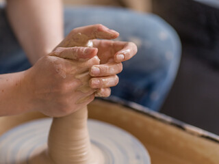 Closeup shot of female ceramic artist works on pottery wheel in studio space, Creative People Handcrafted 