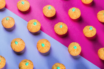 small marshmallow pumpkins with a sprinkle of sugar on a colored background