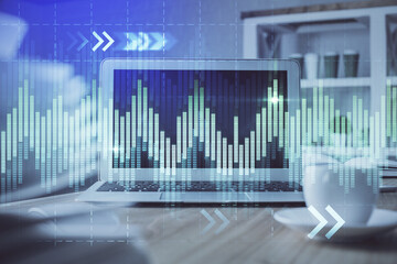 Financial chart drawing and table with computer on background. Double exposure. Concept of international markets.