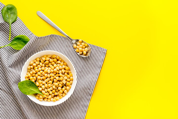 Chickpeas dishes. Vegan healthy food on yellow desk top view copy space