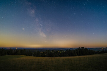 The Milky Way over the Hegau Mountains as seen from the summit of the mountain Witthoh near Tuttlingen in Germany.