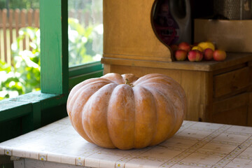 An orange pumpkin is on the table