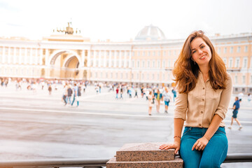 A beautiful woman with long hair visits the tourist city of Saint Petersburg while staying at the...