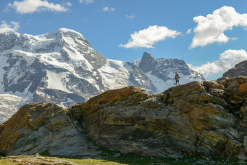 Fototapeta na wymiar Man hiking near the peak of Gornergrat over Zermatt on the Swiss alps