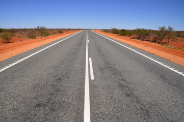 Fototapeta na wymiar Long distances and red dirt driving in outback Australia
