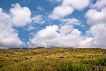 Obraz premium ase camp at Ararat Mountain, approximate elevation of 3300 meters with green pasture and rocks is full of mountaineers in Agri, Turkey