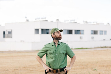 white man with security-watching beard controlling population areas and manufacturing