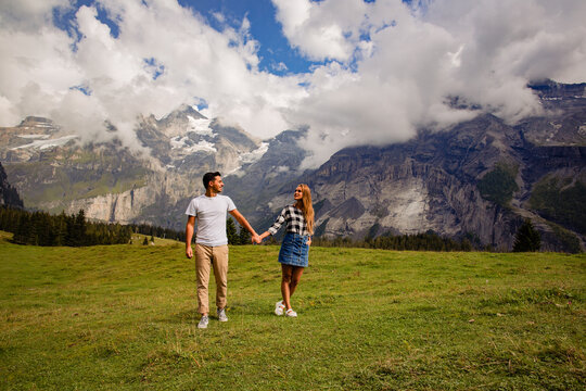 Beautiful couple posing together with mountains in background