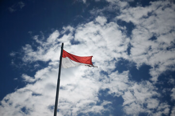 Indonesian flag isolated on blue background.