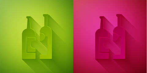 Paper cut Bottles of wine icon isolated on green and pink background. Paper art style. Vector Illustration.
