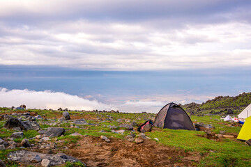 ase camp at  Ararat Mountain, approximate elevation  of 3300 meters with green pasture and rocks ...
