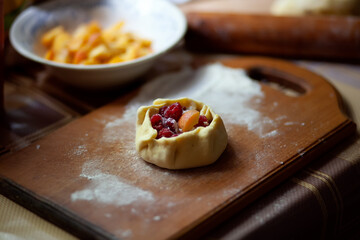 Cooking biscuits (tart) with raspberries and apricots step by step. Ready tart on a board with flour