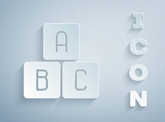 Paper cut ABC blocks icon isolated on grey background. Alphabet cubes with letters A,B,C. Paper art style. Vector Illustration.