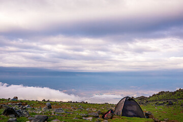 ase camp at  Ararat Mountain, approximate elevation  of 3300 meters with green pasture and rocks ...