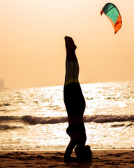 young woman doing yoga on the beach