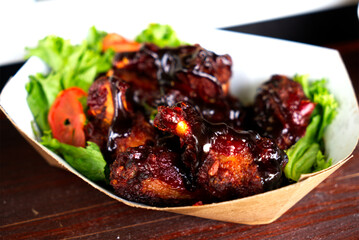 Chicken legs with salad and tomato in a bowl