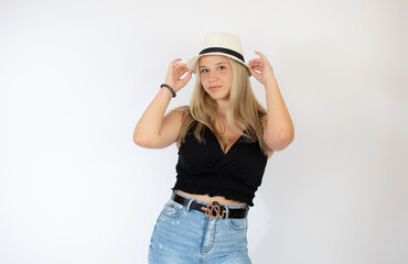 Fototapeta premium Beautiful blonde girl with straw hat posing