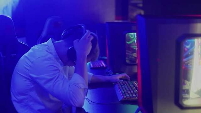 Young man loses in a computer game, competitions in a cyber club. Guy is upset by the loss of an online game.