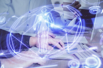 Science hologram with man working on computer on background. Concept of study. Double exposure.