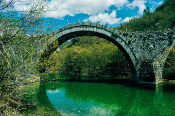 Fototapeta na wymiar The arc of an old bridge in Epirus' mountains