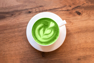 Fresh flavored green matcha on wooden background.